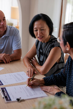 Couple reviews documents with lawyer
