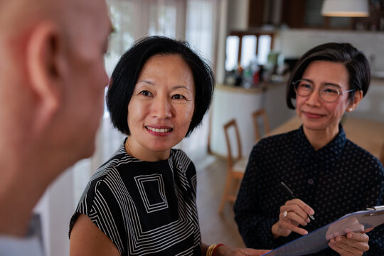 Wife listens to her husband with their realtor