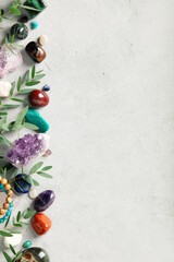 Healing Crystals and Green Leaves on Textured Concrete Background