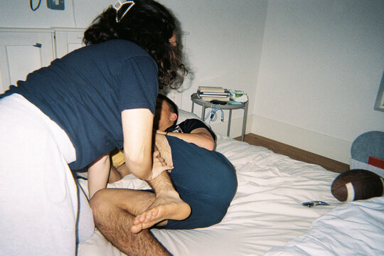Playful tickle fight on the bed