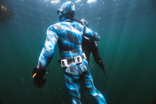 Freediver Being Rescued by Instructor in Open Water