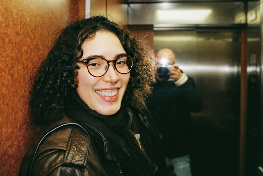 Portrait of a Woman Smiling in an Elevator With a Photographer