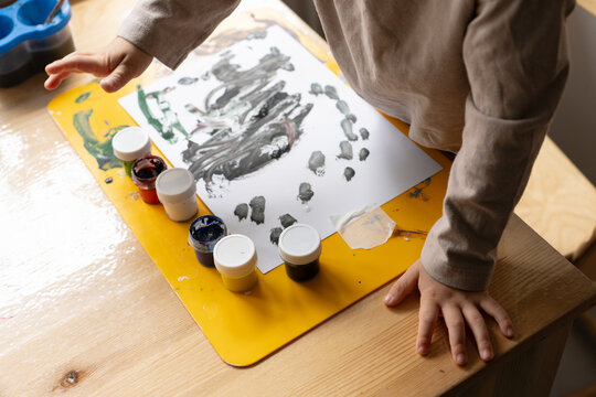 The Child Draws With Paints