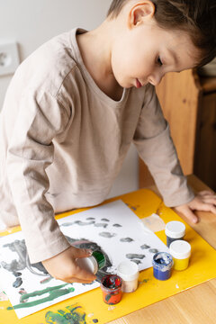 The Child Draws With Paints
