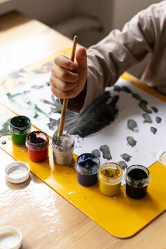 The Child Draws With Paints