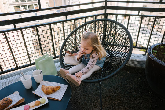 Girl eating on hotel balcony