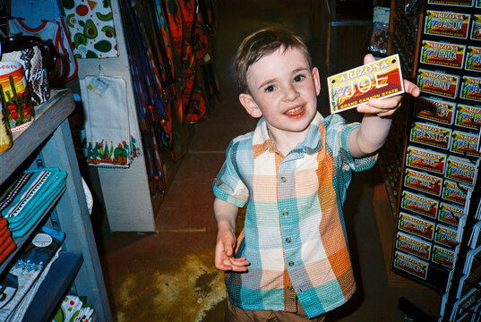 Child on vacation in tourist souvenir shop