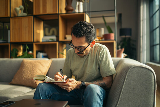 Man writing ideas on his notebook