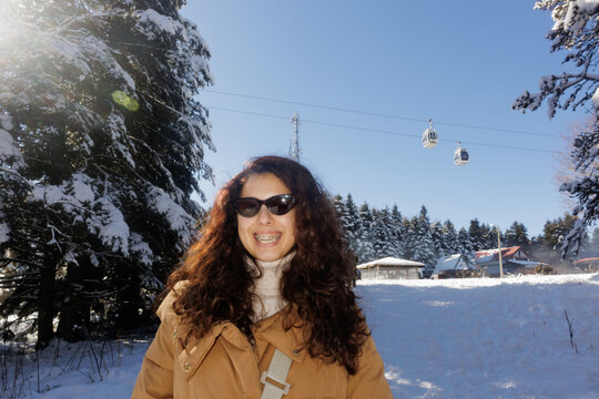 Portrait of a young woman in a winter forest at a ski resort