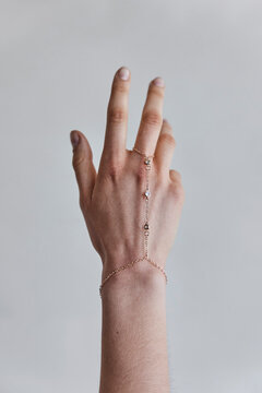 Hand with golden hand chain bracelet