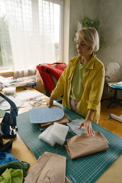 Tailor works with fabrics