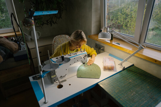 Tailor works on a sewing machine