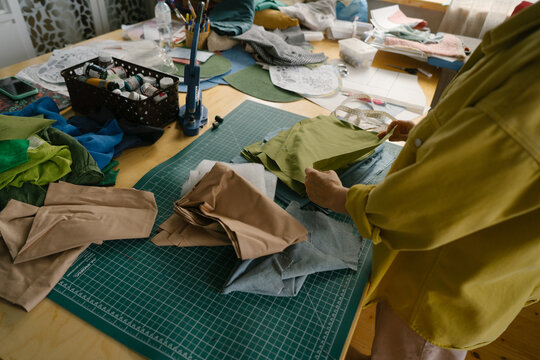 Tailor works with fabrics