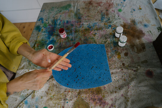 Working with paints and brushes in the workshop