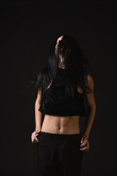 Nonbinary model wearing black clothes backwards 