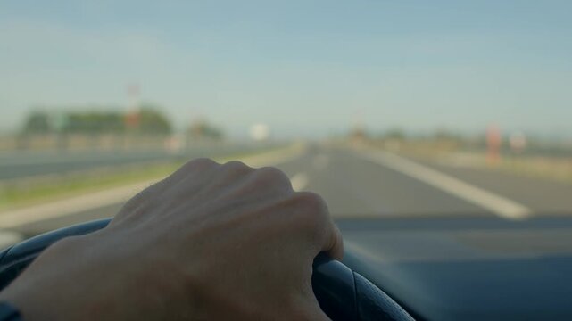Road vehicle control, Driver manages lane change swiftly, Vehicle navigation during rapid overtaking maneuver, Onroad viewpoint showing hands steering during sudden lane overtaking action