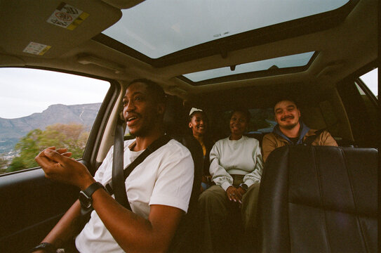 Friends Enjoying a Road Trip Through Scenic Views