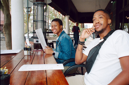 Friends Sitting at an Outdoor Cafe 