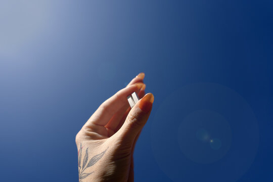 Handful of dietary supplements held by a woman