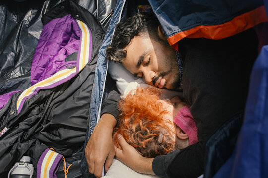 Men resting peacefully in a makeshift shelter