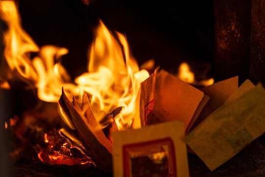 The moment the paper money burned fiercely inside the incense burner