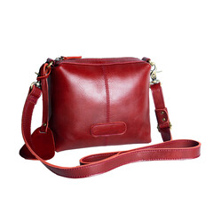 A beautiful red leather sling bag isolated on a white background, perfect for women's style. Suitable for designing leather product catalogs.