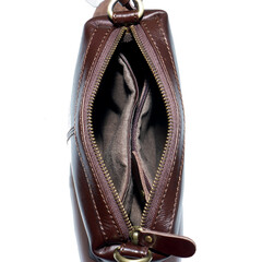 Open and empty leather bag isolated on white background