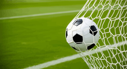 Classic black and white soccer ball caught in a white net on a vibrant green field.