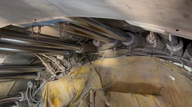 Railway tunnel excavation through mountainous terrain on line LK104 using TBM technology. Tunnel boring machine advancing underground with installation of precast concrete segments forming the tunnel.