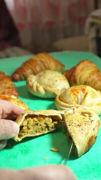 Cutting in half a Empanada Argentina..