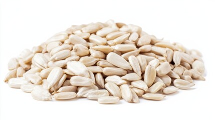 Hulled white sunflower seeds sit in a pile on a white background ready for snacking and recipes