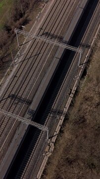 Railway Tracks from Above: A high-angle view showcases a network of parallel railway tracks stretching into the distance, framed by a dry, grassy landscape under a clear sky.