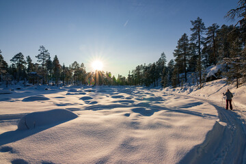 Person cross country skiing on the frozen surface of Lake Inari in Finnish Lapland near Ivalo. © julen