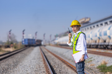 Railway Engineer Communicating by Radio at Freight Yard