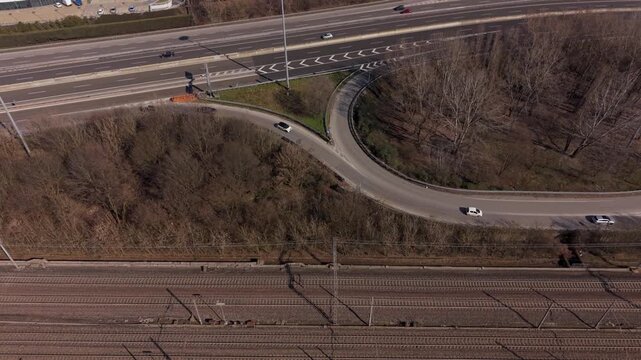 Aerial View of Highway Intersection and Railway Tracks: An aerial perspective showcases a complex highway intersection alongside parallel railway tracks.