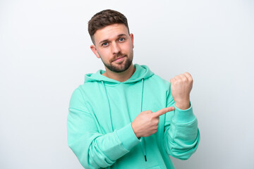 Young caucasian man isolated on white background making the gesture of being late