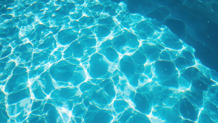 Obraz premium Sunlight shimmering on the surface of a clear blue swimming pool