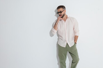 Pensive man touching lip and looking to side