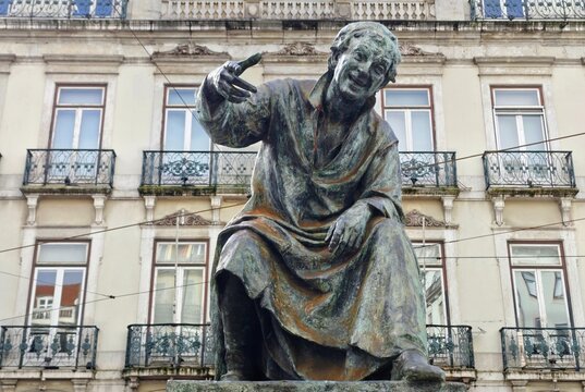 Photo of the statue of Antonio Ribeiro (1520-1591), a celebrated 16th-century satirical poet, standing in Chiado Square, within the civil parish of Misericordia in Lisbon, Portugal.