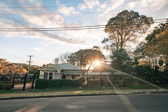 Sun setting over historic school building in the suburbs