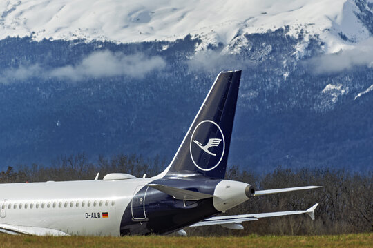 Geneva, Switzerland - february 13, 2026 : sign and logo on a Airbus A319 of Lufthansa at Geneva Airport with Snow-covered Jura mountains rise in the background