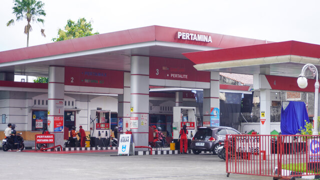 The situation at the pertamina gas station or spbu saw lots of cars and trucks queuing up to refuel. A filling station, also known as petrol or gas station. Car, truck, motorcycle.