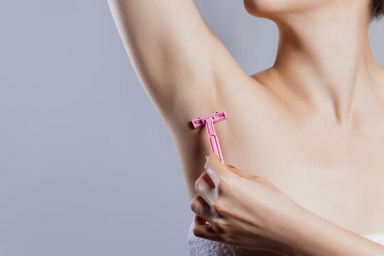 Hands are shaved, armpits or plucking the armpits by using a razor, Depilation and skin care concept.
