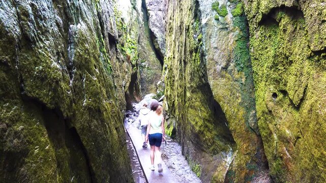 Two little beautiful girls walk near Szczeliniec Wielki - highest peak in Table Mountains National Park, Poland. It belongs to Crown of Polish Mountains and is landscape reserve.