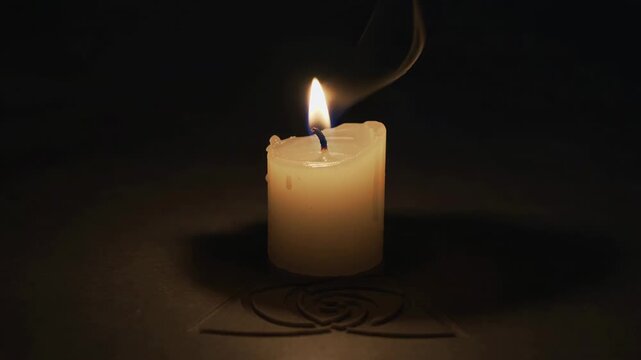 Imbolc. Candlelight to smoke transformation: timelapse of a burning candle extinguishing