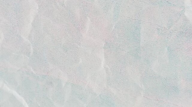 Textured pale blue and white background revealing subtle creases and imperfections for artistic designs