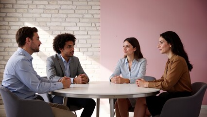 Four people in a business meeting