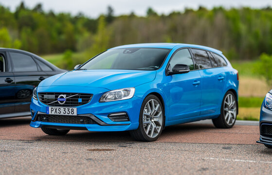 Gothenburg, Sweden - May 11 2025: Blue 2015 Volvo V60 station wagon on rural road.