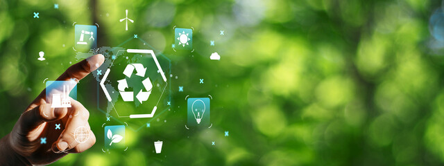 Hand touching eco icons with recycling symbol on green blurred background for sustainability concept and environmental awareness theme."" © Who is Danny