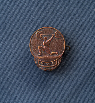 Lindesnes, Norway - July 21 2025: Bronze Weightlifter Sports Achievement Pin Emblem.